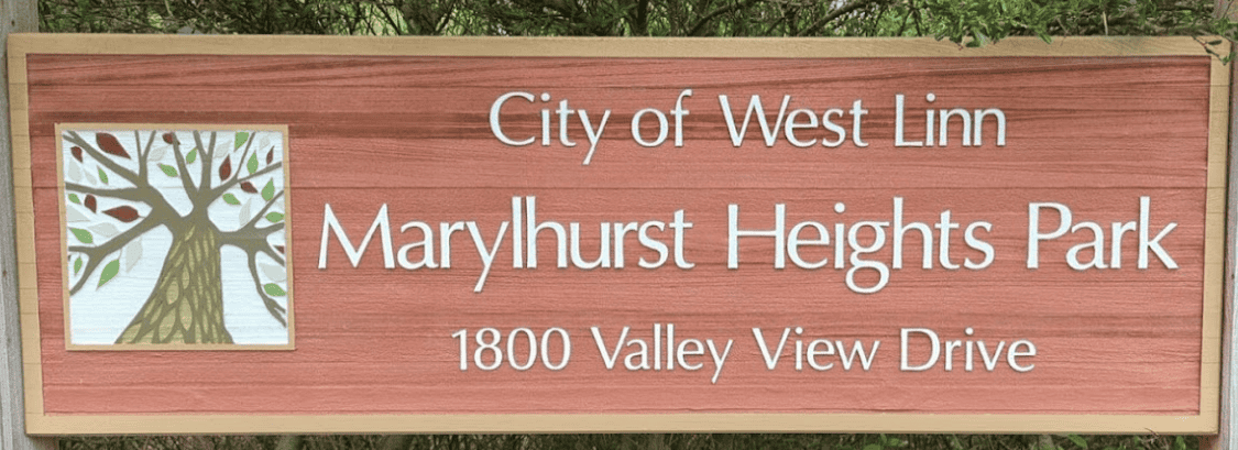 West Linn Marylhurst Heights Park sign, vibrant wood sign with park name and address, surrounded by greenery, emphasizing local park location and natural environment.