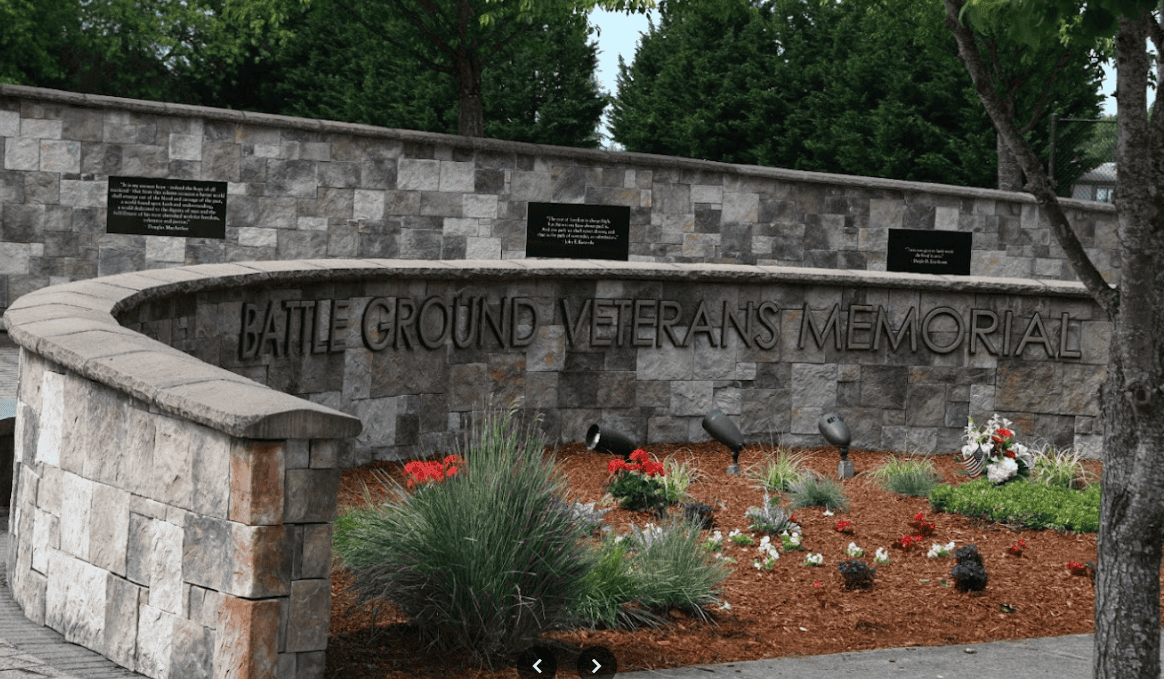 Battle Ground Veterans Memorial with stone wall and landscaping, dedicated to honoring military veterans.